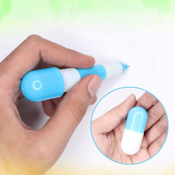 Hand holding a Capsule-Shaped Writing Pen in blue, showcasing its playful design for smooth writing.