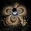Outdoor Solar Garden Lantern casting intricate spiral patterns of light on the ground in a garden setting.