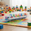 Transparent Mechanical Gear Train Toy showing colorful gears and numbers on a play mat with building blocks.