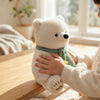 Child hugging a 23cm Plush Polar Bear with a green scarf, perfect for cozy playtime and bedtime snuggles.
