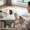 Smart Wireless Wi-Fi Indoor Security Camera monitoring home activities with mobile connectivity.