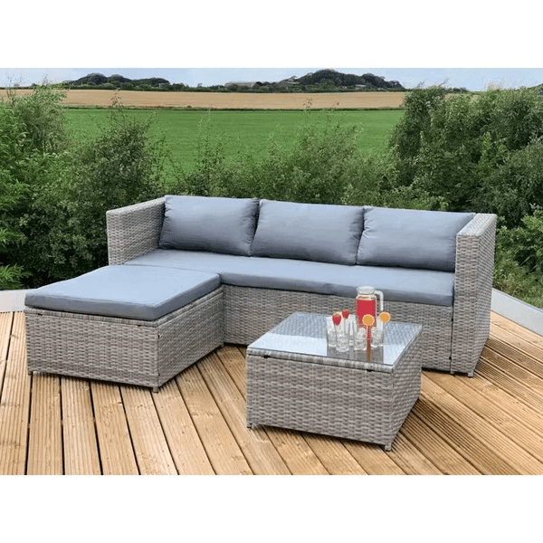 Garden Lounge Set with Grey Cushions placed on a wooden deck with drinks on a glass table.