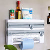4 In 1 Wall Mounted Paper Towel Foil Wrap Dispenser with condiments and paper towels on a kitchen wall.