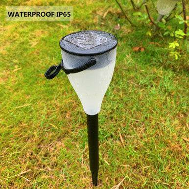 Sun Glow 6 Pack Solar Garden Light Set showcasing a waterproof solar garden light in grass.