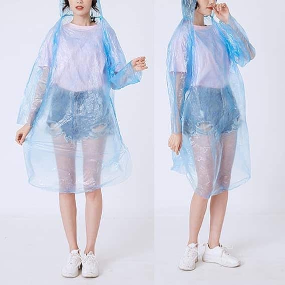 Woman wearing a blue Disposable Raincoat Ball, demonstrating lightweight rain protection for unexpected weather.