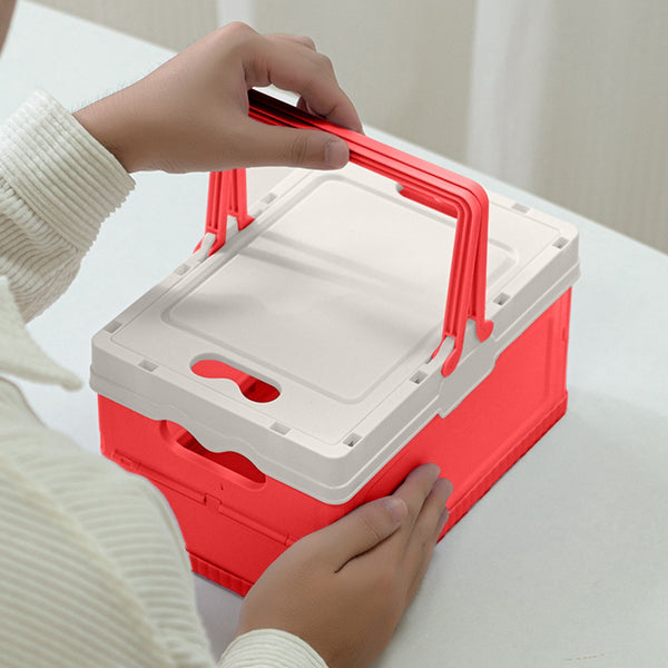 Person holding a Foldable Plastic Camping Storage Box with a red base and white lid for easy transport.