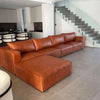 Genuine Leather U-Shaped Sectional Couch in a modern living room setting with a stylish staircase.