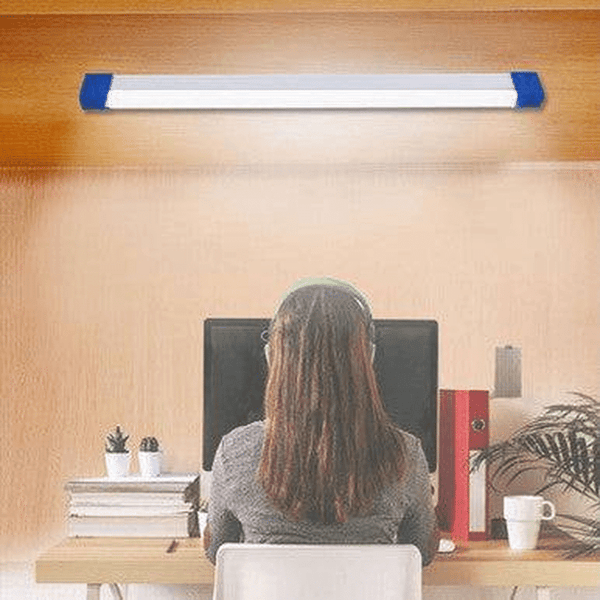 Portable Solar LED Emergency Light System installed above a workspace with a person seated at a desk.