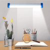 Portable Solar LED Emergency Light System illuminating a desk with plants, stationery, and a magnifying glass.