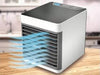 Arctic Air Conditioner emitting cool air, designed for personal space cooling and humidifying.