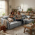 Couple enjoying drinks on the Bina Cinematic Couch in a cozy living room setting with a dog.