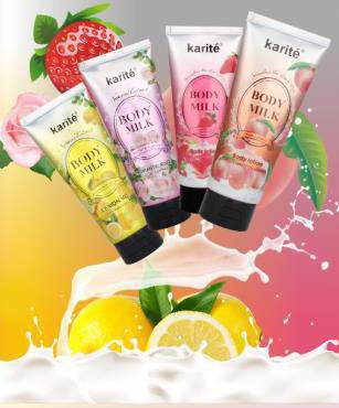 Four tubes of Body Milk Body Lotion by Karité, featuring fruit scents, with splash of citrus in the background.