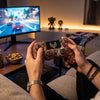 Person using Wireless Gaming Controller with Dual Vibration while playing a racing game on TV.
