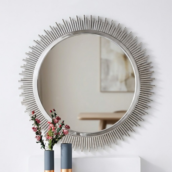 Sunburst Decorative Round Wall Mirror with metallic spikes and floral arrangement in front, enhancing interior decor.