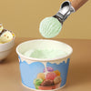 Stainless Steel Fruit & Dessert Scoop lifting mint ice cream from a colorful ice cream cup.