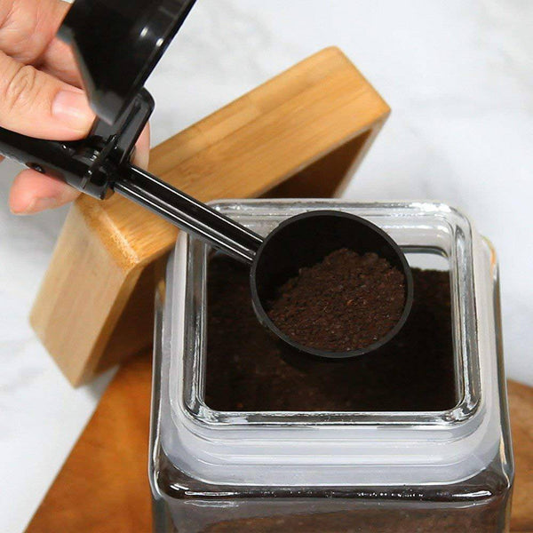 2 in 1 Coffee Scoop and Funnel being used to measure coffee grounds from a jar.