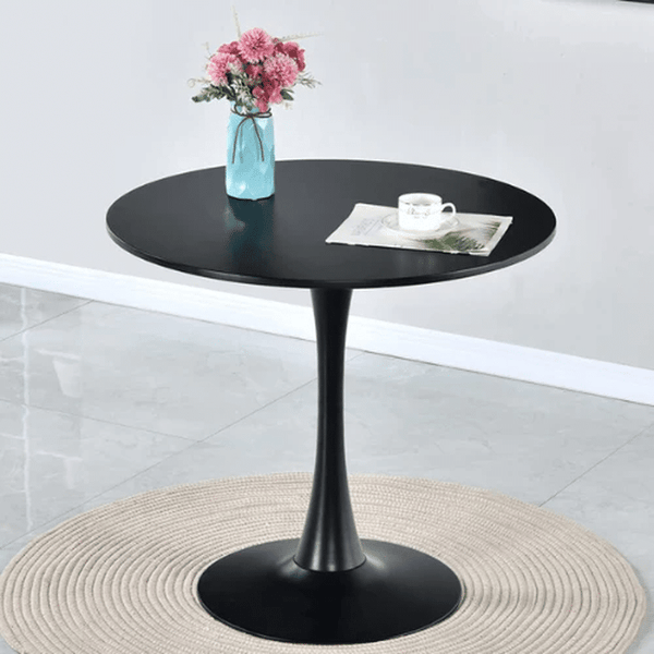 Round Dining Table with black finish and stylish design, featuring a vase of flowers and a cup on top.