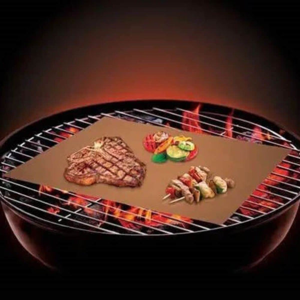 Copper Grill and Bake Mat showcasing grilled steak and vegetables on a barbecue grill.