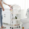 Person using the 4 Layer Gap Kitchen Storage Rack Slim Slide Tower in a bathroom setting for organization.