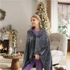 USB Heated Electric Shawl Blanket being worn by a woman in a cozy living room with holiday decorations.