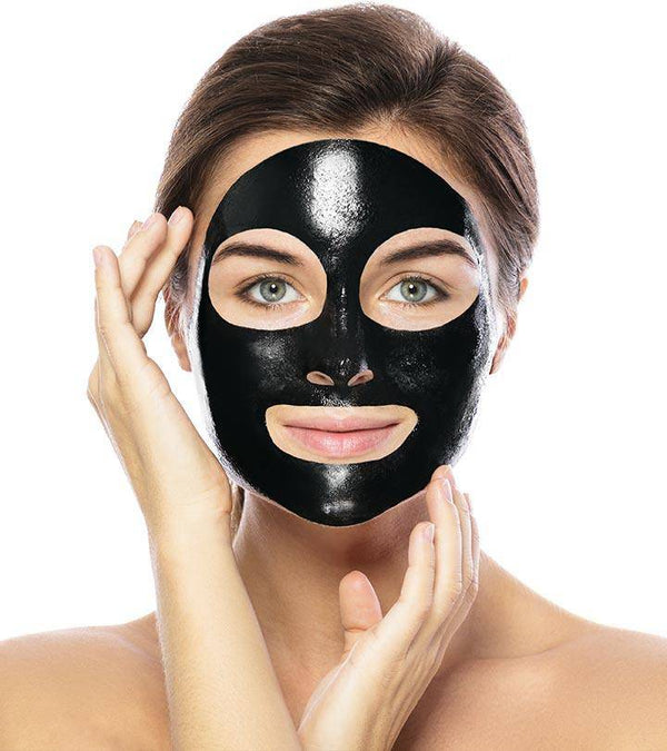 Woman applying Charcoal Blackhead Removal Mask on her face for effective skincare.