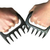 Two hands holding Braai Claws for shredding and handling meat safely and easily.