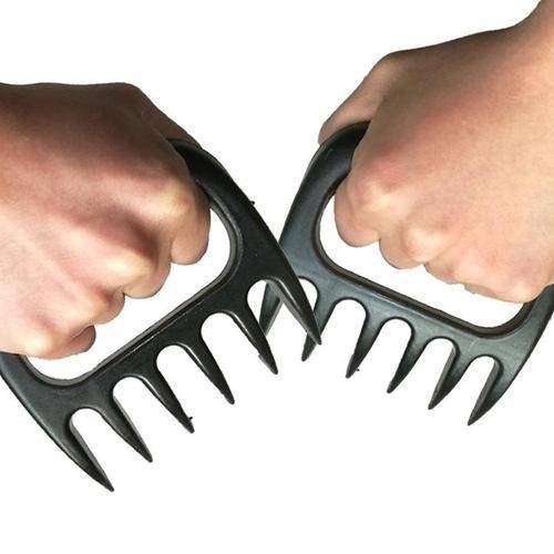 Two hands holding Braai Claws for shredding and handling meat safely and easily.