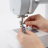 Hands attaching presser foot to sewing machine using the 11-Piece Sewing Machine Presser Feet Kit.