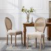 Vintage French Dining Chair with Rattan Back placed next to a wooden table in a stylish interior.