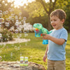 Child using the Dino Light-Up Bubble Gun - Assorted, creating bubbles outdoors in a sunny setting.
