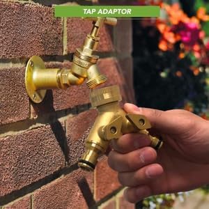 Brass 2-Way Garden Hose Splitter with Stop Valves attached to a wall with a hand operating it.