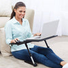Woman using an Adjustable Laptop Desk while sitting on the floor, working comfortably with a laptop.