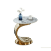 Side Accent Table with a stylish curved base, marble top, vase, and cup, perfect for modern living spaces.