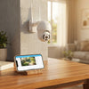 V380 Pro PTZ Outdoor Security Camera mounted on a wall with a smartphone displaying its remote control features.