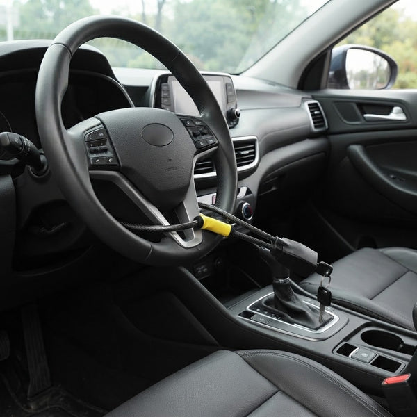 Car Steering Wheel Wire Rope Lock installed on a steering wheel for anti-theft security in a vehicle interior.