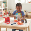 Kitchen Helper Happy Little Chef Pretend Play set with a young girl using toy knives and food for imaginative kitchen play.