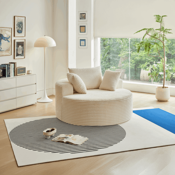 Round Corduroy Lounge Chair for Cozy Spaces in a modern living room setting with decorative pillows.