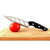 Aero Knife slicing a tomato on a wooden cutting board showcasing its aerodynamic blade design.