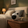 Compact Mini Electric Fan Heater on bedside table in cozy bedroom setting.