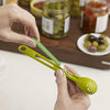 Hands using the 2 Piece Scoop and Pick Jar Spoon and Fork for easy condiment access.