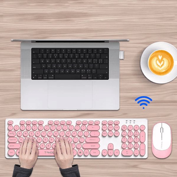 2.4 G Wireless Keyboard & Mouse Set in pink with laptop and coffee for a stylish workspace.