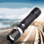 20 000 Lumen Adjustable LED Torch – High-Power Portable Flashlight on a winding road with city backdrop.