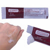 50 Piece Vitamin A + Vitamin D Healing Ointment on a hand, showcasing the emollient texture of the ointment.