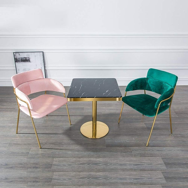 Square Marble Effect Dining Table with Gold Pedestal Base paired with pink and green chairs in modern dining space.