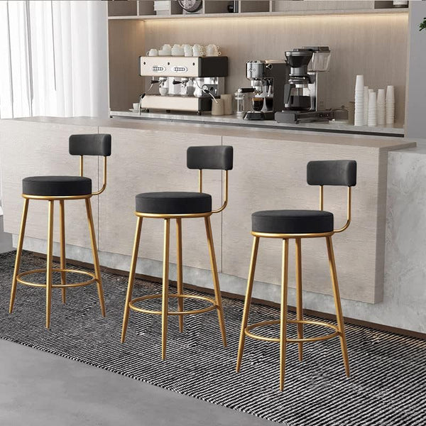 Modern Upholstered Dining Chair set at a sleek kitchen bar with golden legs and black seating.