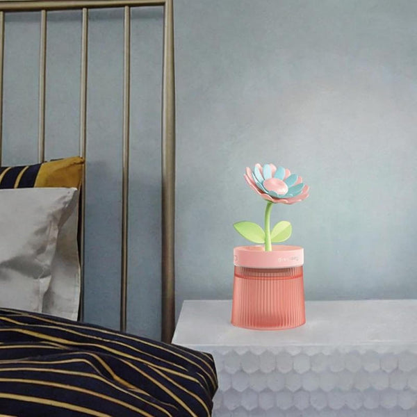 Flower Design Mini USB Air Humidifier & Aroma Diffuser on nightstand next to bed enhances comfort and decor.