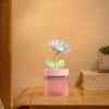 Flower Design Mini USB Air Humidifier & Aroma Diffuser on a bedside table with a warm background.
