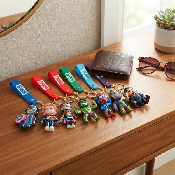 3D Superhero Character Keychain collection displayed on a wooden table with a wallet and sunglasses.