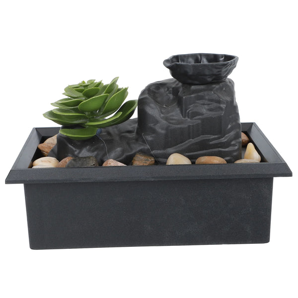 Solar Raindrop Tabletop Water Fountain with decorative plants and stones for indoor decor.