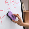 A hand using a Magnetic Whiteboard Eraser to clean a whiteboard surface.